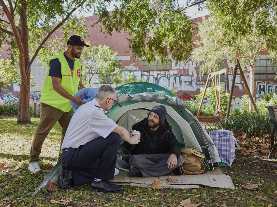 Salvos helping someone experiencing homelessness and living in a tent