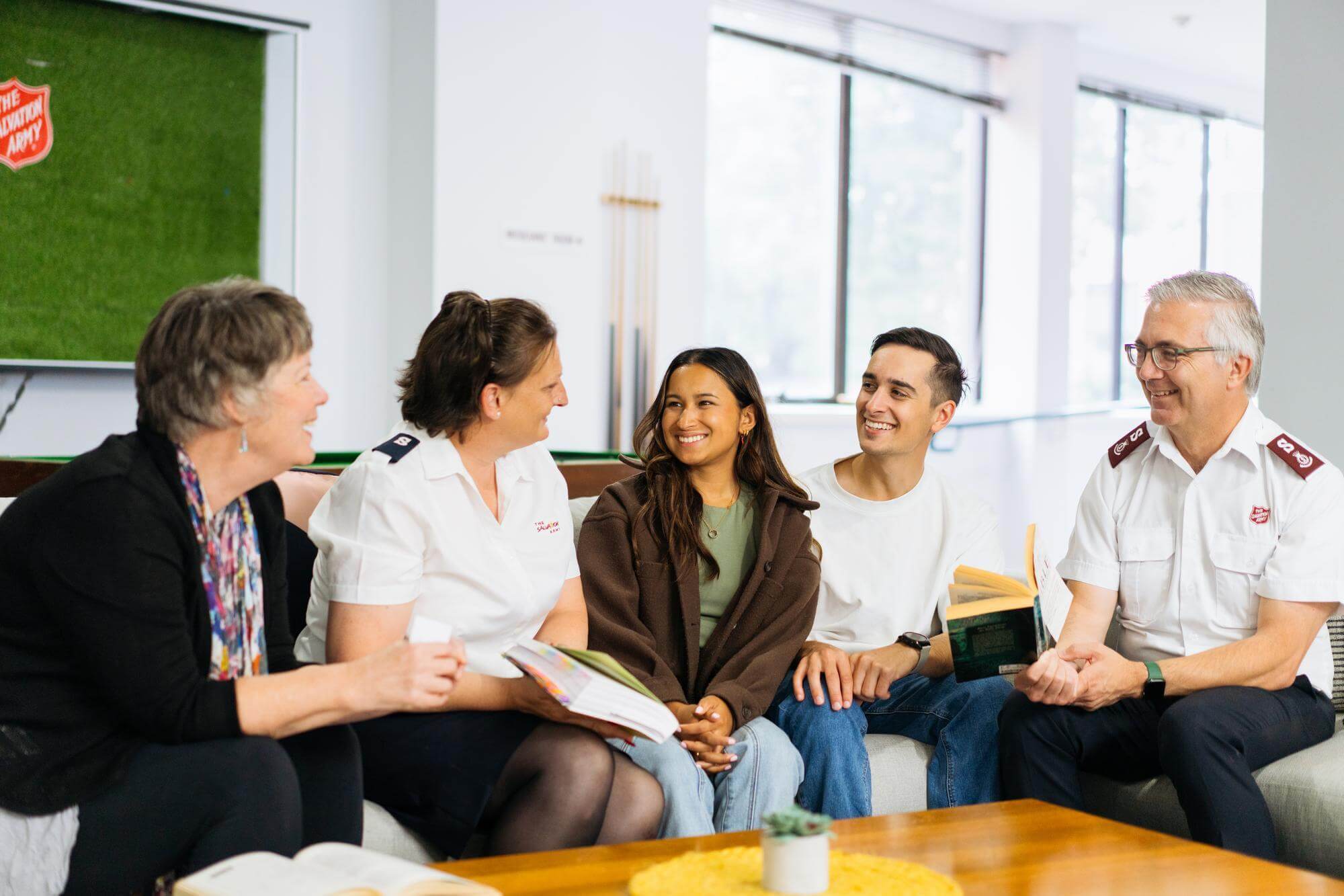 People conversing around coffee table
